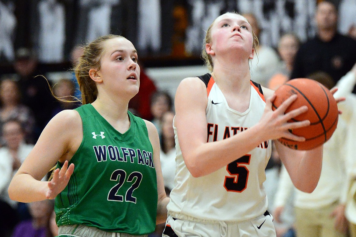 Flathead's Maddy Moy (5) drives to the basket past Glacier's Ellie Keller (22) during a crosstown matchup with Glacier at Flathead High School on Thursday. (Casey Kreider/Daily Inter Lake)