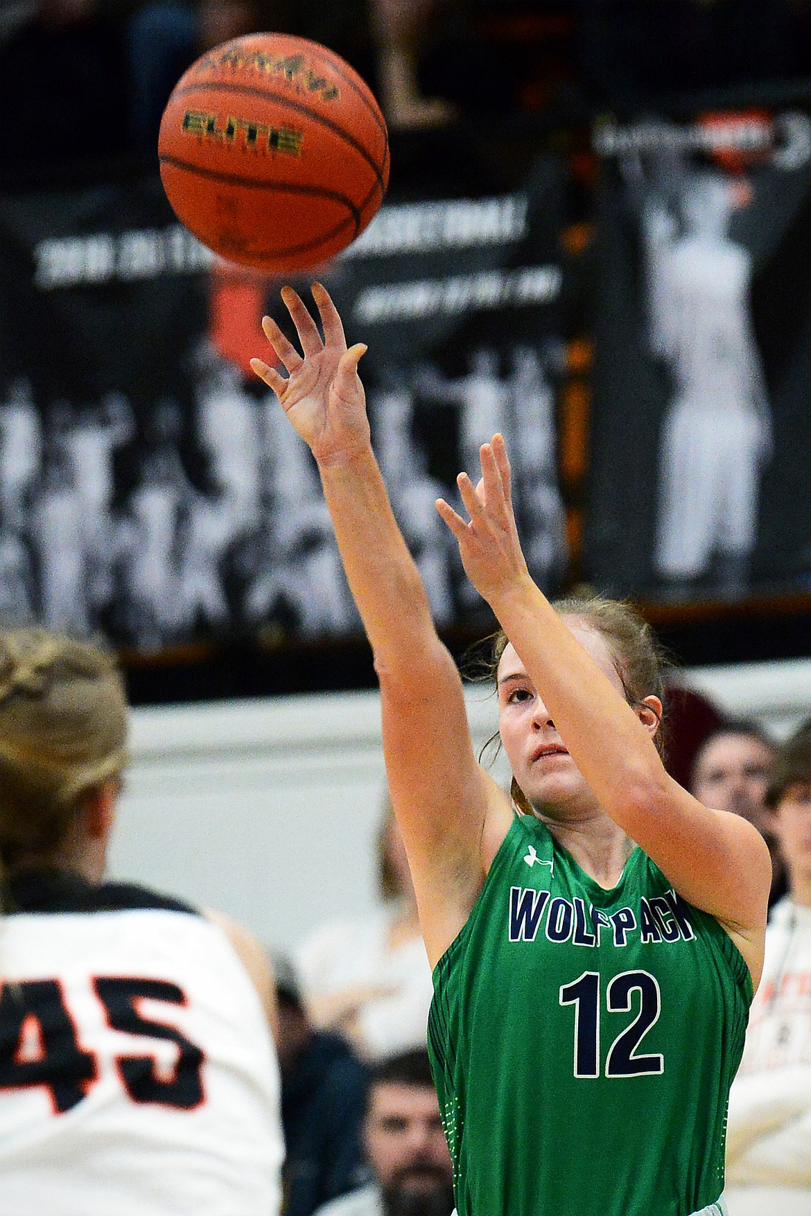 Glacier's Kenzie Williams (12) sinks a three in front of Flathead's Rebecca Eacker (45) during the first half of a crosstown matchup at Flathead High School on Thursday. (Casey Kreider/Daily Inter Lake)