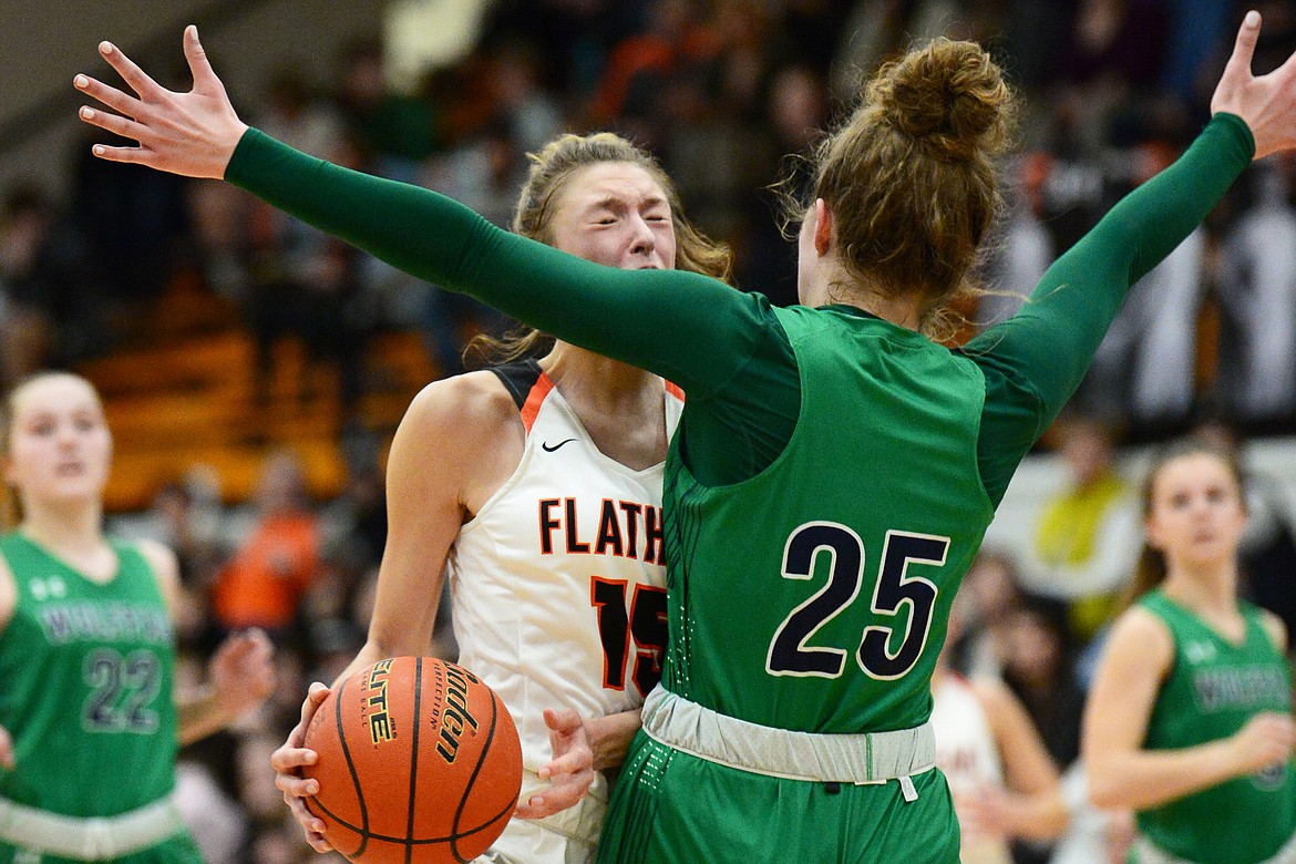 Flathead's Clare Converse (15) runs into the defense of Glacier's Emma Anderson (25) during a crosstown matchup with Glacier at Flathead High School on Thursday. (Casey Kreider/Daily Inter Lake)