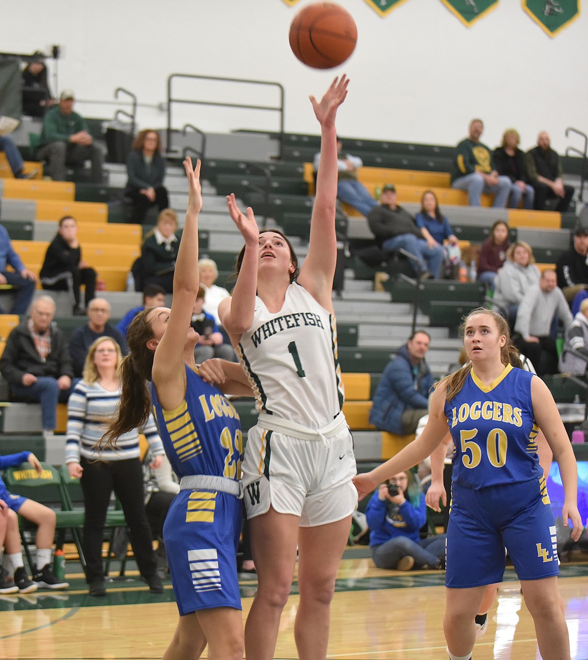 Lady Bulldog Jadi Walburn goes up for a shot against the Lady Loggers Friday night at the Whitefish High School gym. (Heidi Desch/Whitefish Pilot)