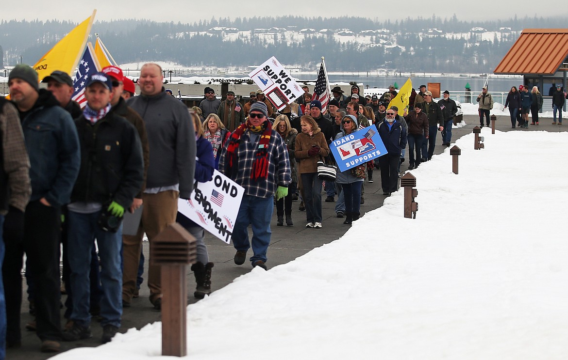 Hundreds of people walk from the Coeur d'Alene Resort clock tower to McEuen Park to attend a second amendment rally. (LOREN BENOIT/Press)