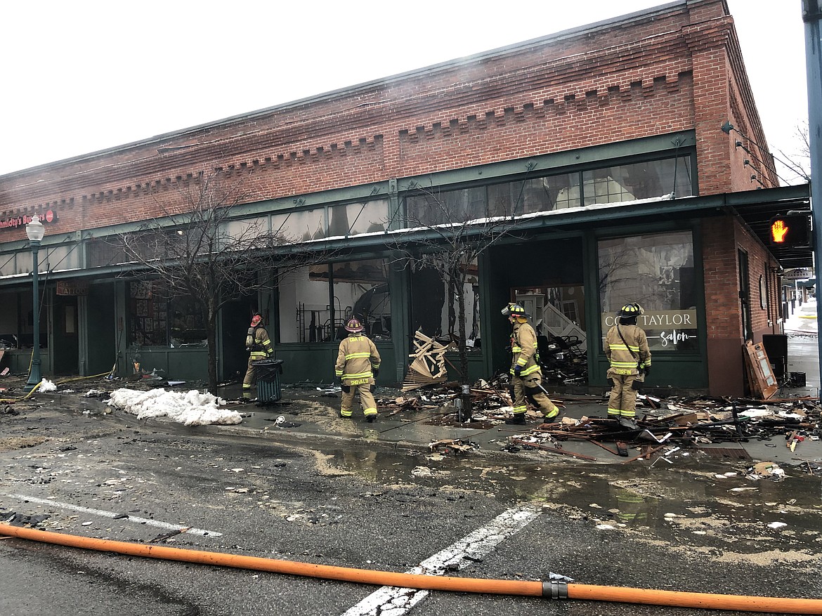 Coeur d&#146;Alene firefighters sort through the rubble of a massive fire at the corner of Lakeside Avenue and Fourth Street in downtown Coeur d&#146;Alene early Monday morning. The blaze reportedly started shortly after 1 a.m. (MIKE PATRICK/Press)