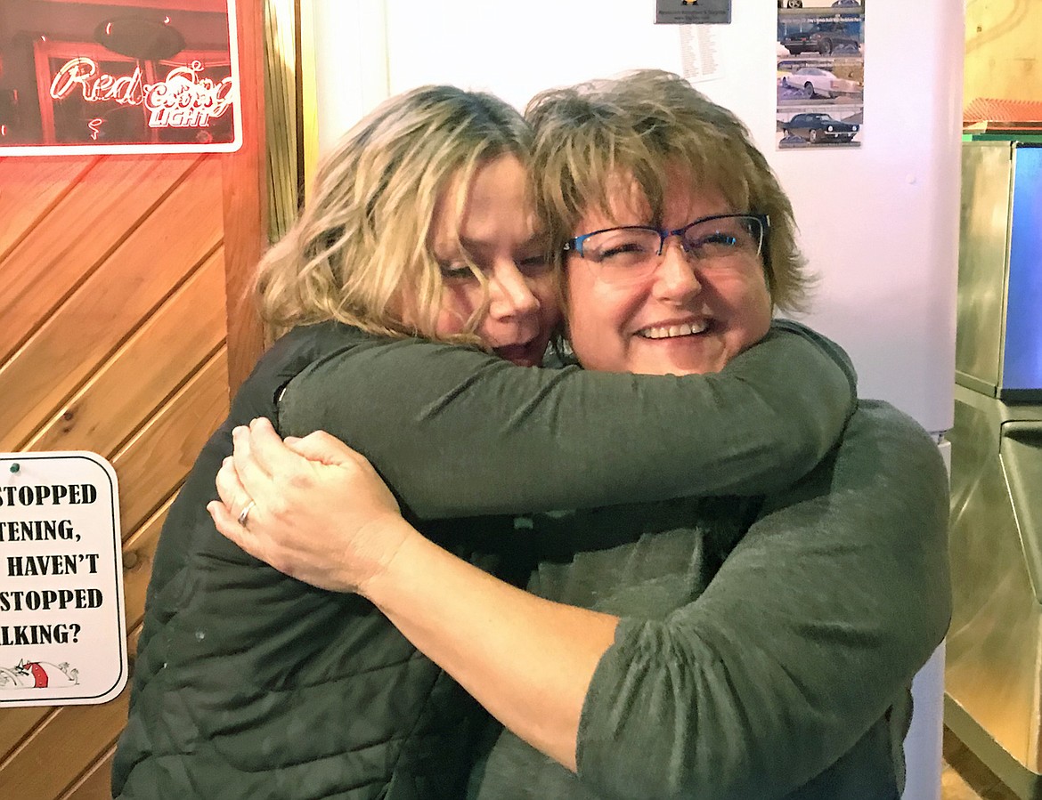 Long time Red Dog employees Kristie Eggers, left, and Ellen Mills share a hug Thursday evening prior to Sunday's closing. (Paul Sievers/The Western News)