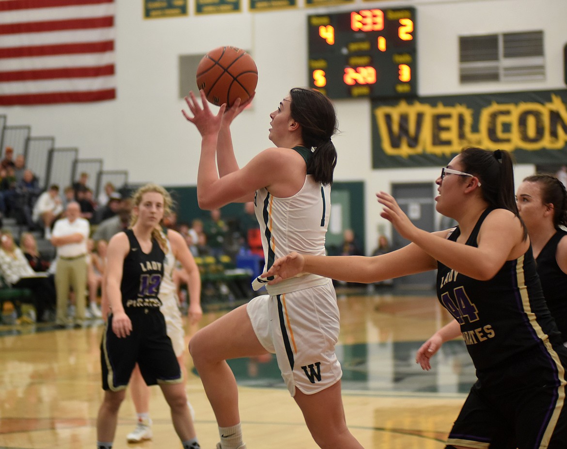 Bulldog sophomore Jadi Walburn goes around the defense looking for the shot Friday night against Polson during the first half at the gym at Whitefish High School. (Heidi Desch/Whitefish Pilot)