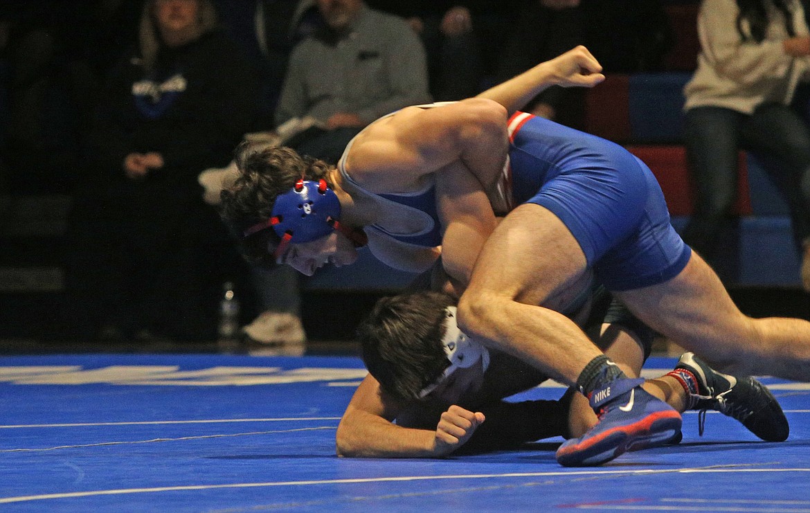 Coeur d&#146;Alene&#146;s Demarco Piazza wrestles with Lake City&#146;s. Gavin Tuttle in the 160 pound Terhark Cup match Wednesday at CHS. (LOREN BENOIT/Press)