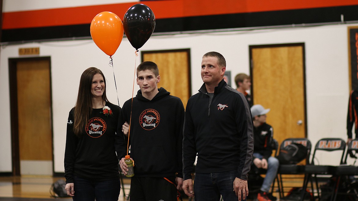 Plains-Hot Springs wrestler Conrad Vanderwall with his parents Zach and Cori Vanderwall for Senior Night. (Lisa Larson/Valley Press)