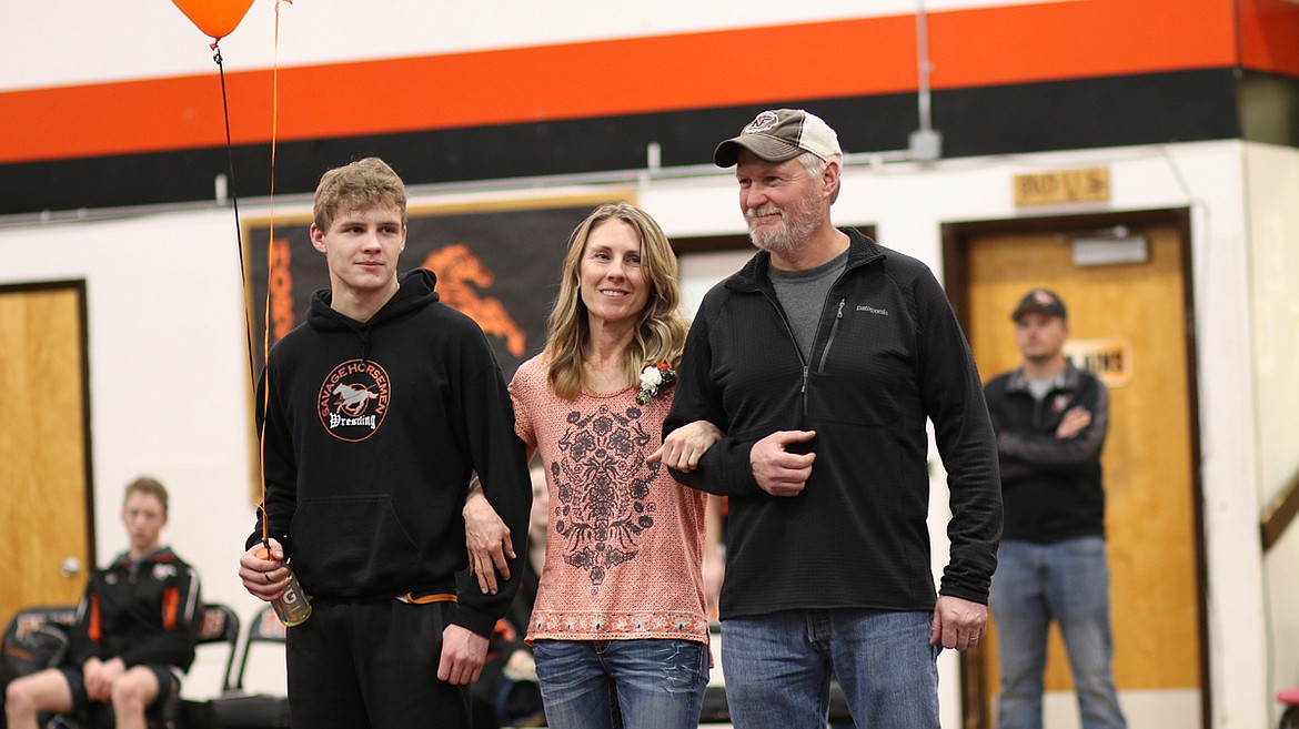 Plains-Hot Springs wrestler Gage Fuhrman with his parents Kon and Cheri Fuhrman for Senior Night. (Lisa Larson/Valley Press)