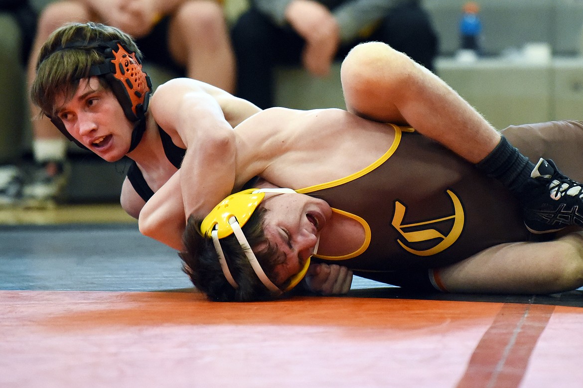 Flathead's Cade Gardner wrestles Helena Capital's Lane O'Shea at 113 lbs. at Flathead High School on Thursday. Gardner won by decision. (Casey Kreider/Daily Inter Lake)