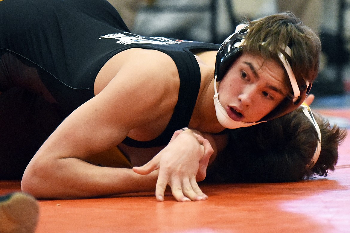 Flathead's Chase Youso works toward a pin of Helena Capital's Ian Isaacson at 160 lbs. at Flathead High School on Thursday. (Casey Kreider/Daily Inter Lake)