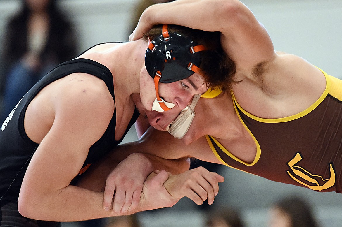 Flathead's Noah Poe-Hatten wrestles Helena Capital's Dylan Graham at 152 lbs. at Flathead High School on Thursday. Poe-Hatten won by decision. (Casey Kreider/Daily Inter Lake)