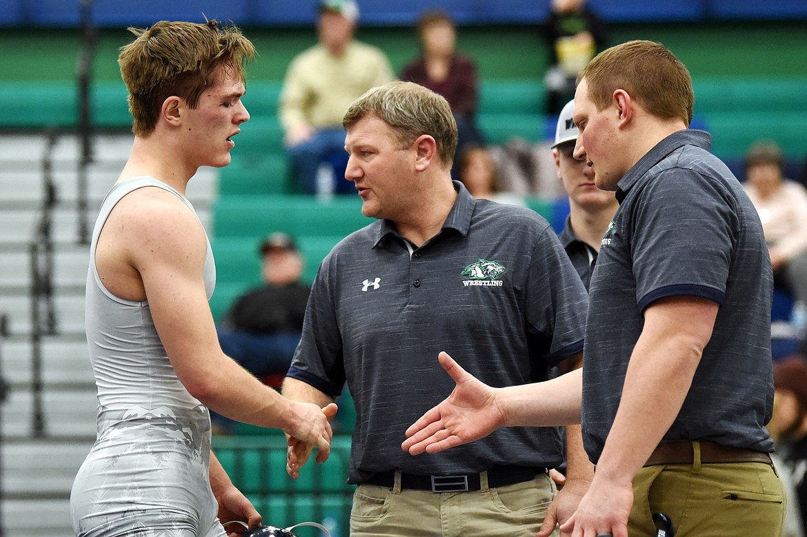 Glacier's Caden Gilmond is congratulated by assistant coach Tim Willis and head coach Ross Dankers after his 18-11 decision over Helena Capital's Ian Isaacson at Glacier High School on Thursday. (Casey Kreider/Daily Inter Lake)