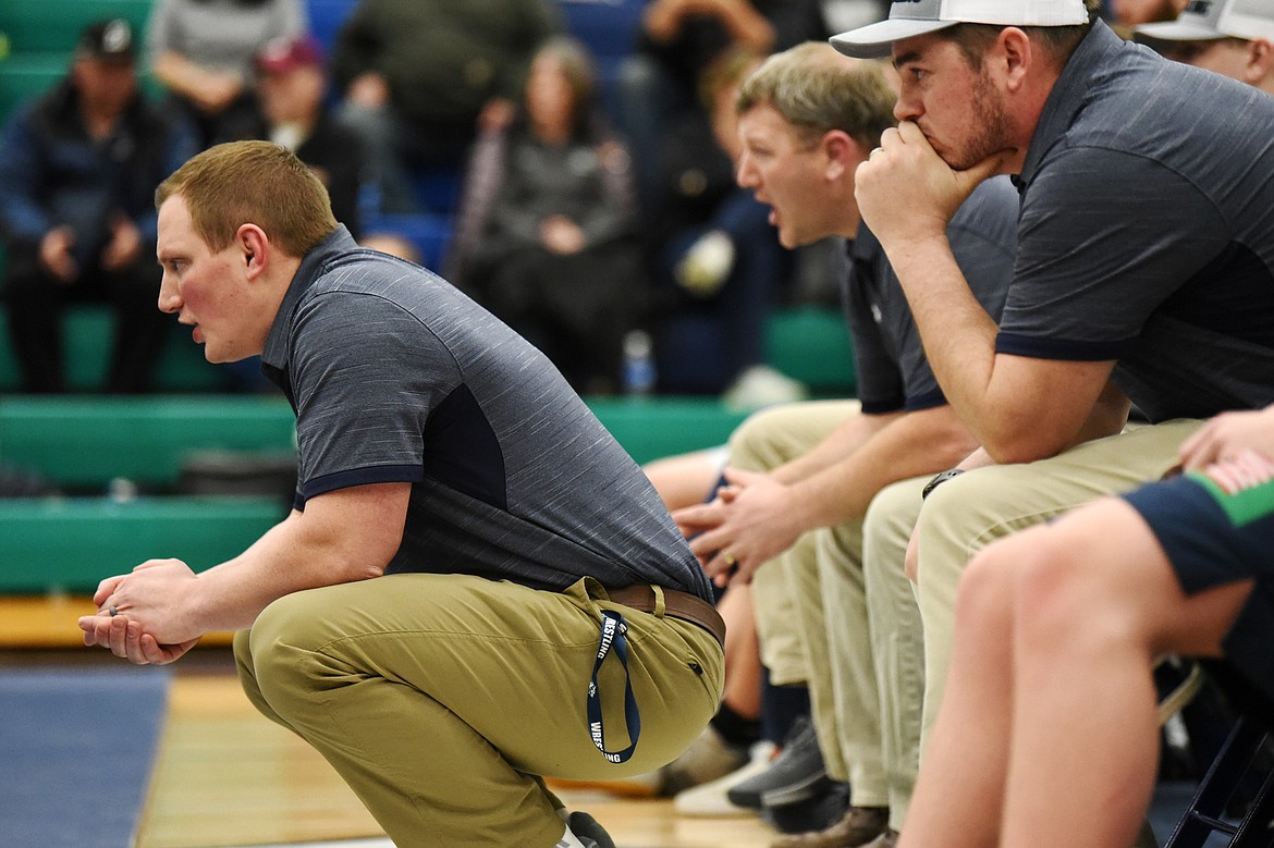 Glacier head coach Ross Dankers coaches up a Wolfpack wrestler from the bench against Helena Capital at Glacier High School on Thursday. (Casey Kreider/Daily Inter Lake)