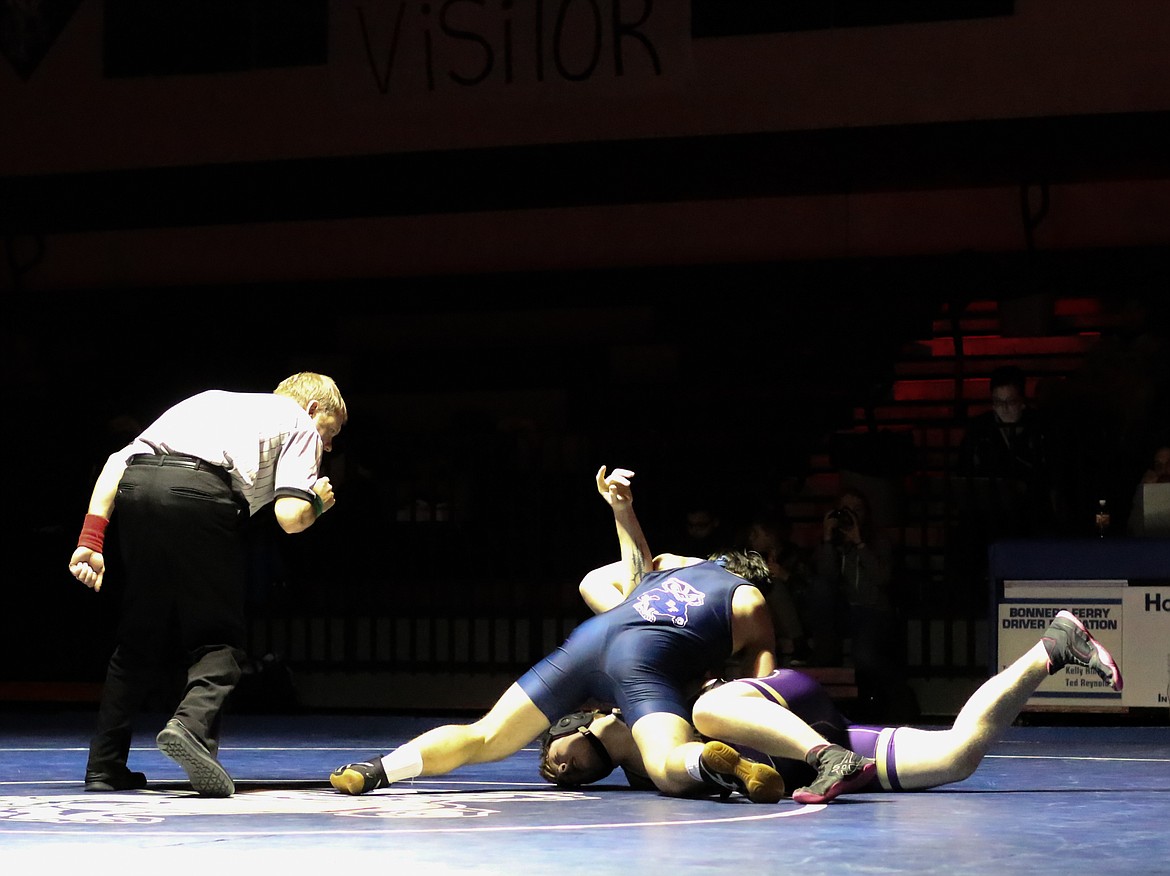 Photo by MANDI BATEMAN
Nathaniel Varelman works toward a pin of Kellogg's Carson Hudson in the 195-pound bout.