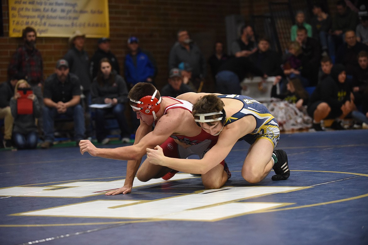 Arlee 145-pounder Colt Crawford works to free himself from the grasp of Missoula Big Sky's Brody Skillicorn during the Ted Kato Invitational Saturday in Thompson Falls. Crawford eventually won the match with a pin. (Scott Shindledecker/Lake County Leader)