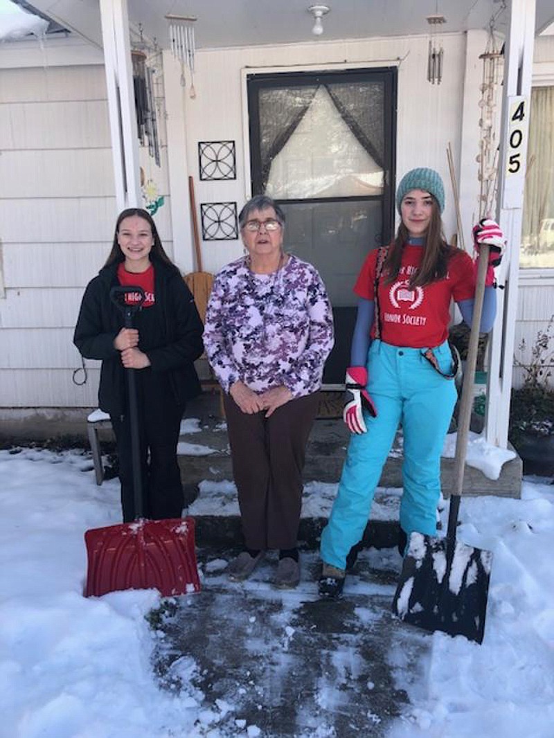 Kayla Goldman and Summer Bonsell take a break from shoveling while at Eva Harrington&#146;s home in Superior. (Angie Armour photo)