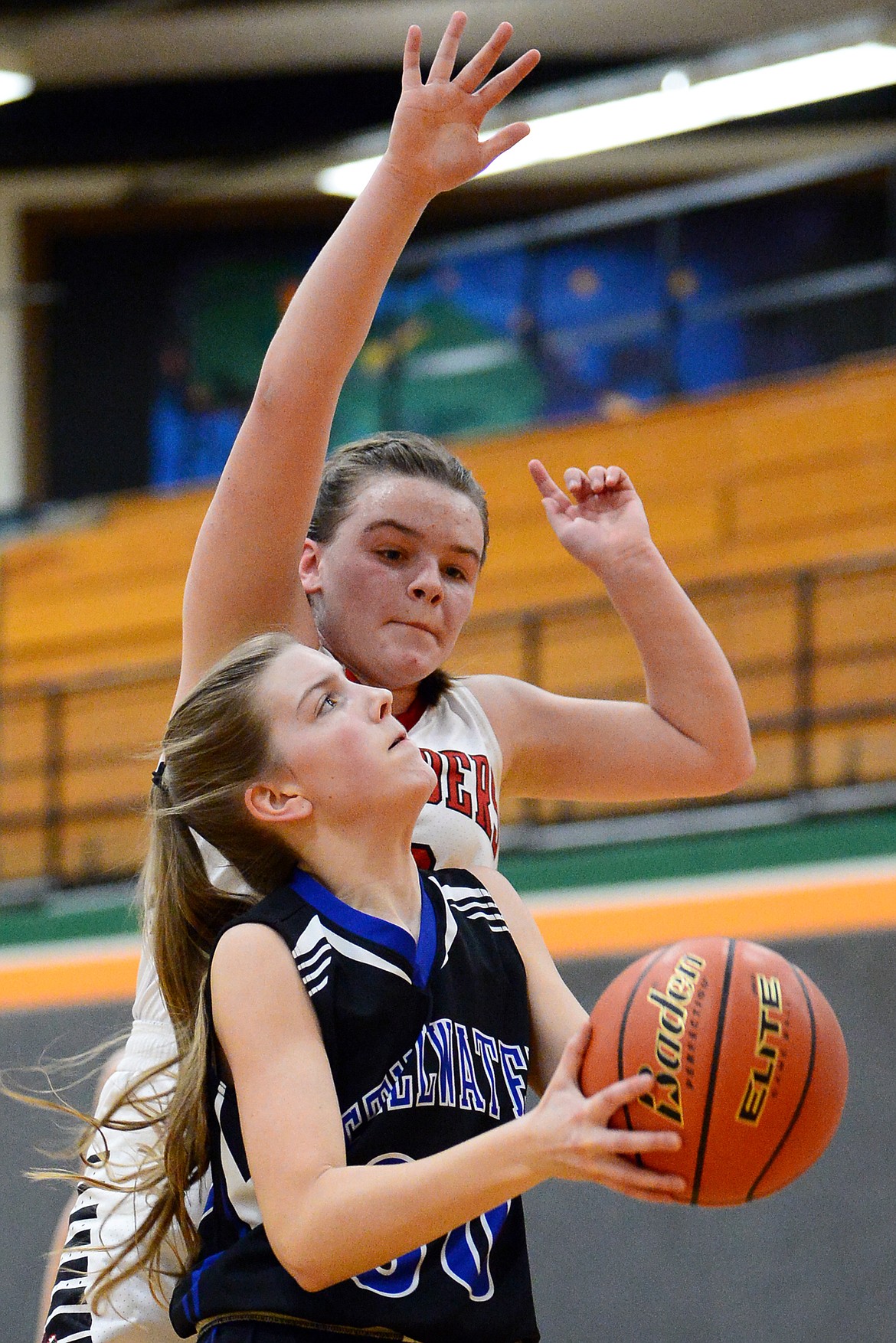 Stillwater Christian's Sophia Sulzbacher (30) drives to the basket with Flathead Valley Home School's Codi Kenney (10) defending at Kalispell Middle School on Saturday. (Casey Kreider/Daily Inter Lake)