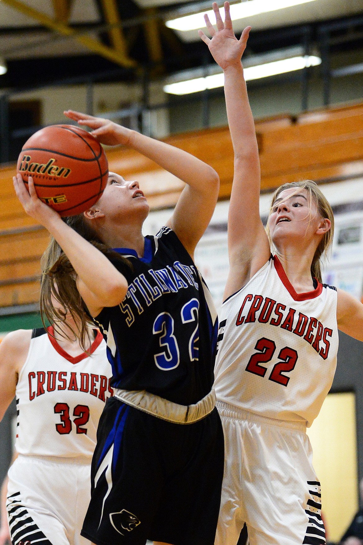 Stillwater Christian's Emma Linn (32) looks to shoot against Flathead Valley Home School's Corey Connerly (22) at Kalispell Middle School on Saturday. (Casey Kreider/Daily Inter Lake)