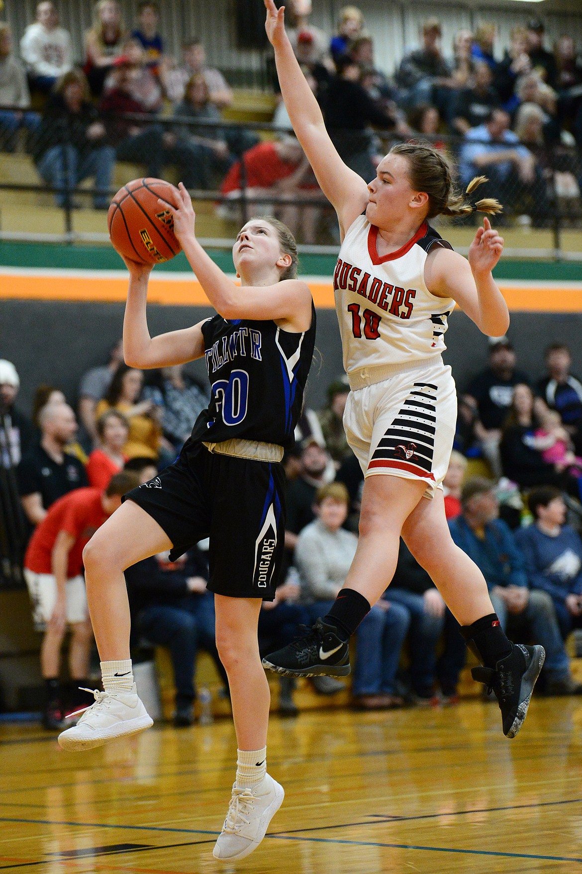 Flathead Valley Home School's Codi Kenney (10) blocks a layup by Stillwater Christian's Sophia Sulzbacher (30) at Kalispell Middle School on Saturday. (Casey Kreider/Daily Inter Lake)