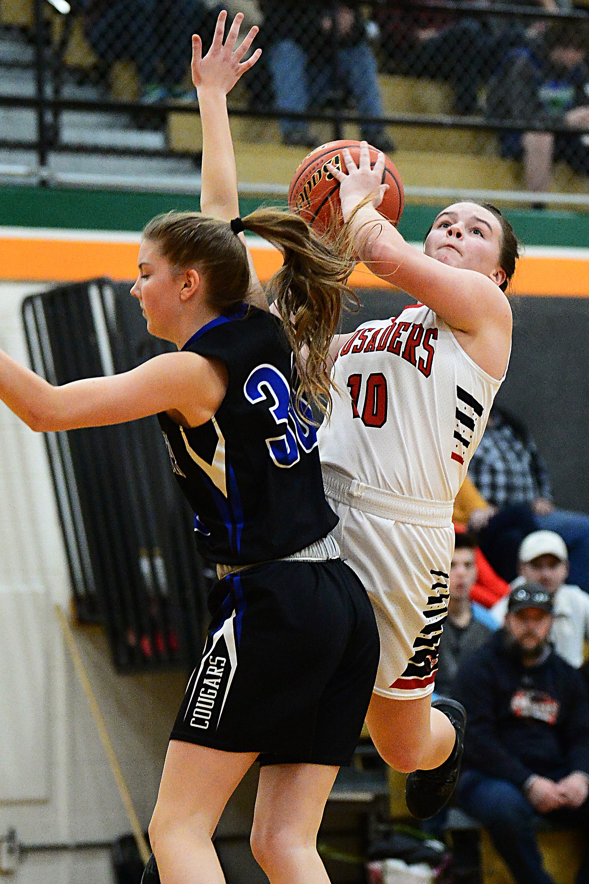 Flathead Valley Home School's Codi Kenney (10) drives to the basket against Stillwater Christian's Sophia Sulzbacher (30) at Kalispell Middle School on Saturday. (Casey Kreider/Daily Inter Lake)