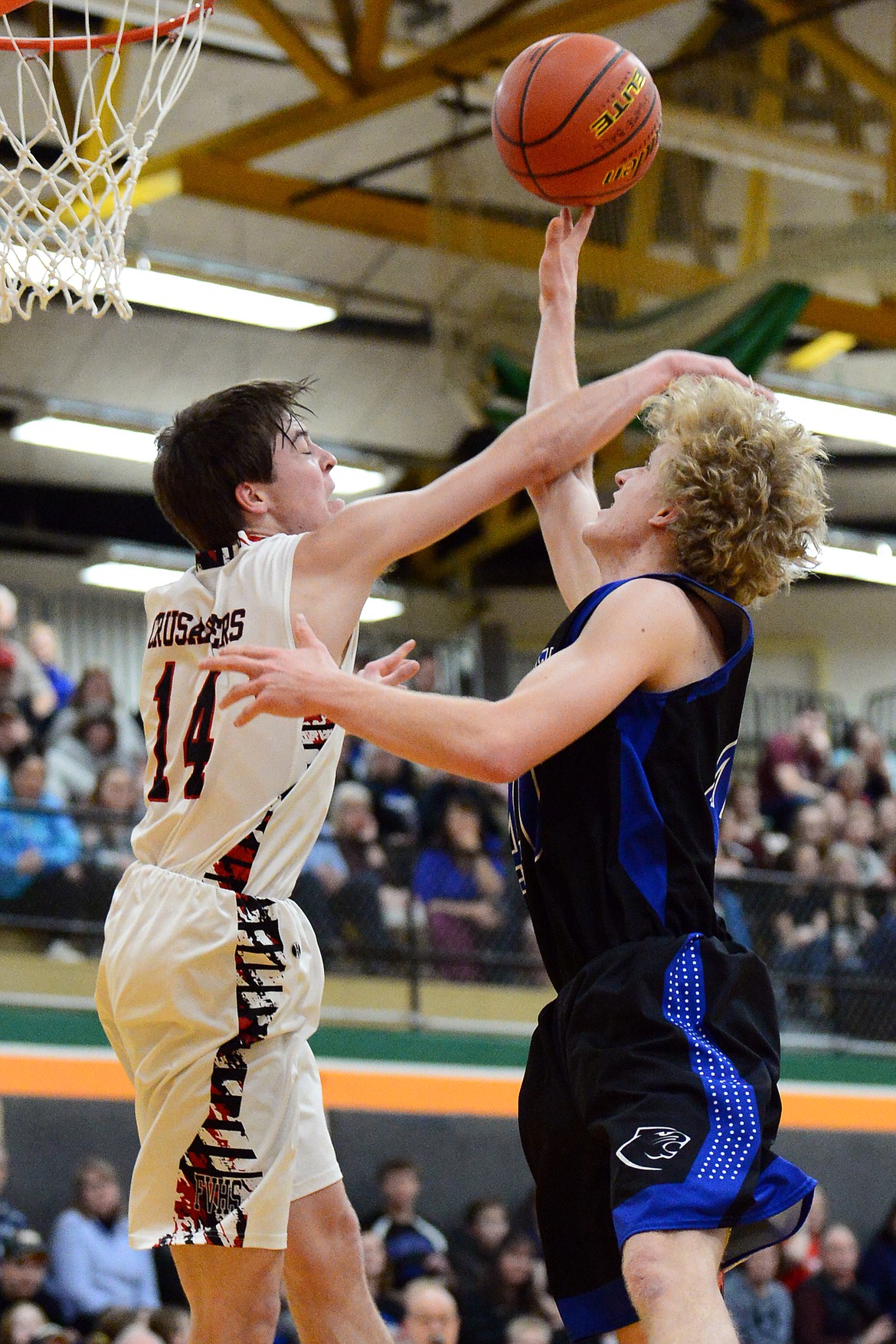 Stillwater Christian's Connor Drish (40) is fouled on his way to the hoop by Flathead Valley Home School's Landan Wininger (14) at Kalispell Middle School on Saturday. (Casey Kreider/Daily Inter Lake)