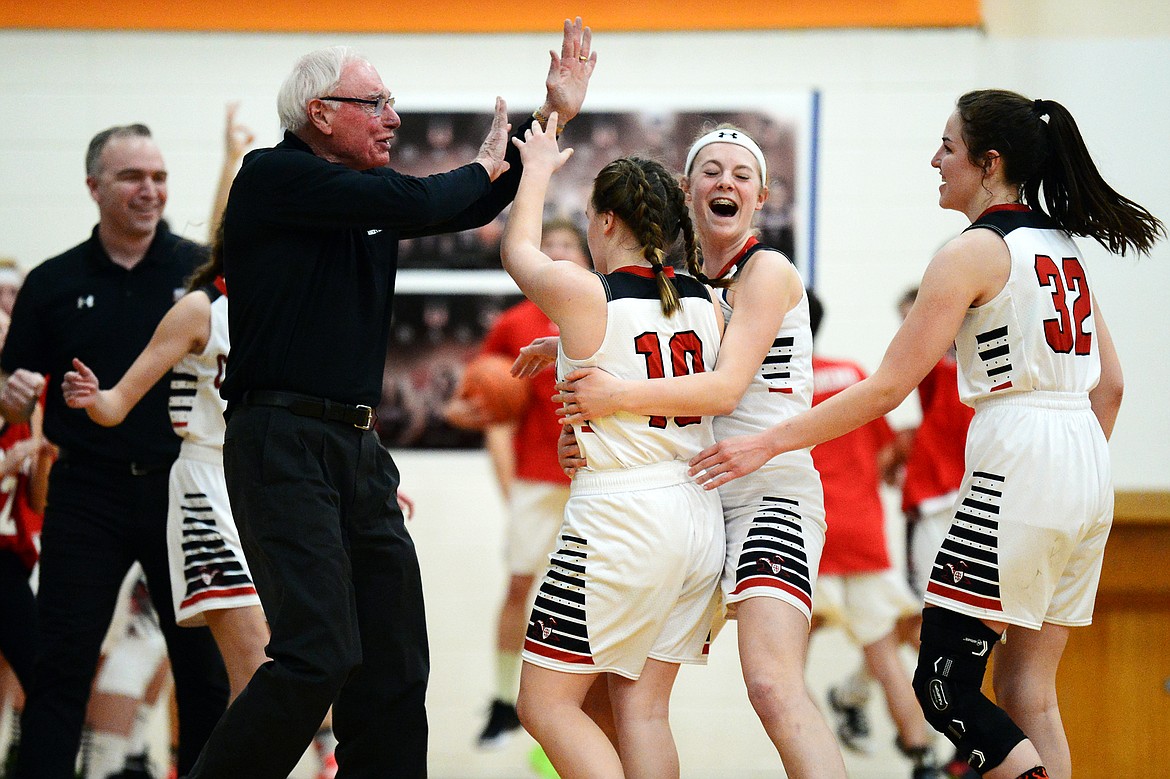 Flathead Valley Home School's Codi Kenney (10), Hannah Buckner (23) and Starlyn Davis (32) celebrate with coaches Mark and Charles Kenney after Codi Kenney sank a three at the buzzer to send the game into overtime against Stillwater Christian at Kalispell Middle School on Saturday. (Casey Kreider/Daily Inter Lake)