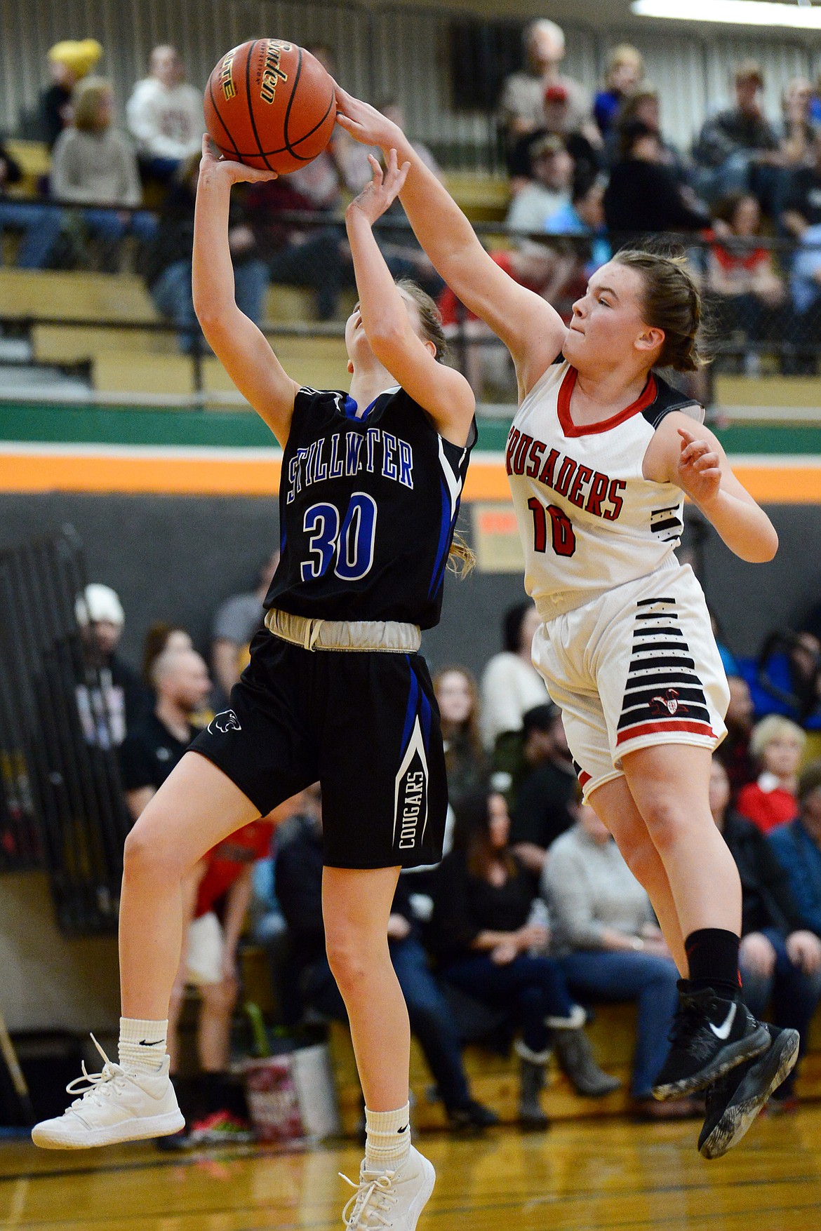 Flathead Valley Home School's Codi Kenney (10) blocks a layup by Stillwater Christian's Sophia Sulzbacher (30) at Kalispell Middle School on Saturday. (Casey Kreider/Daily Inter Lake)