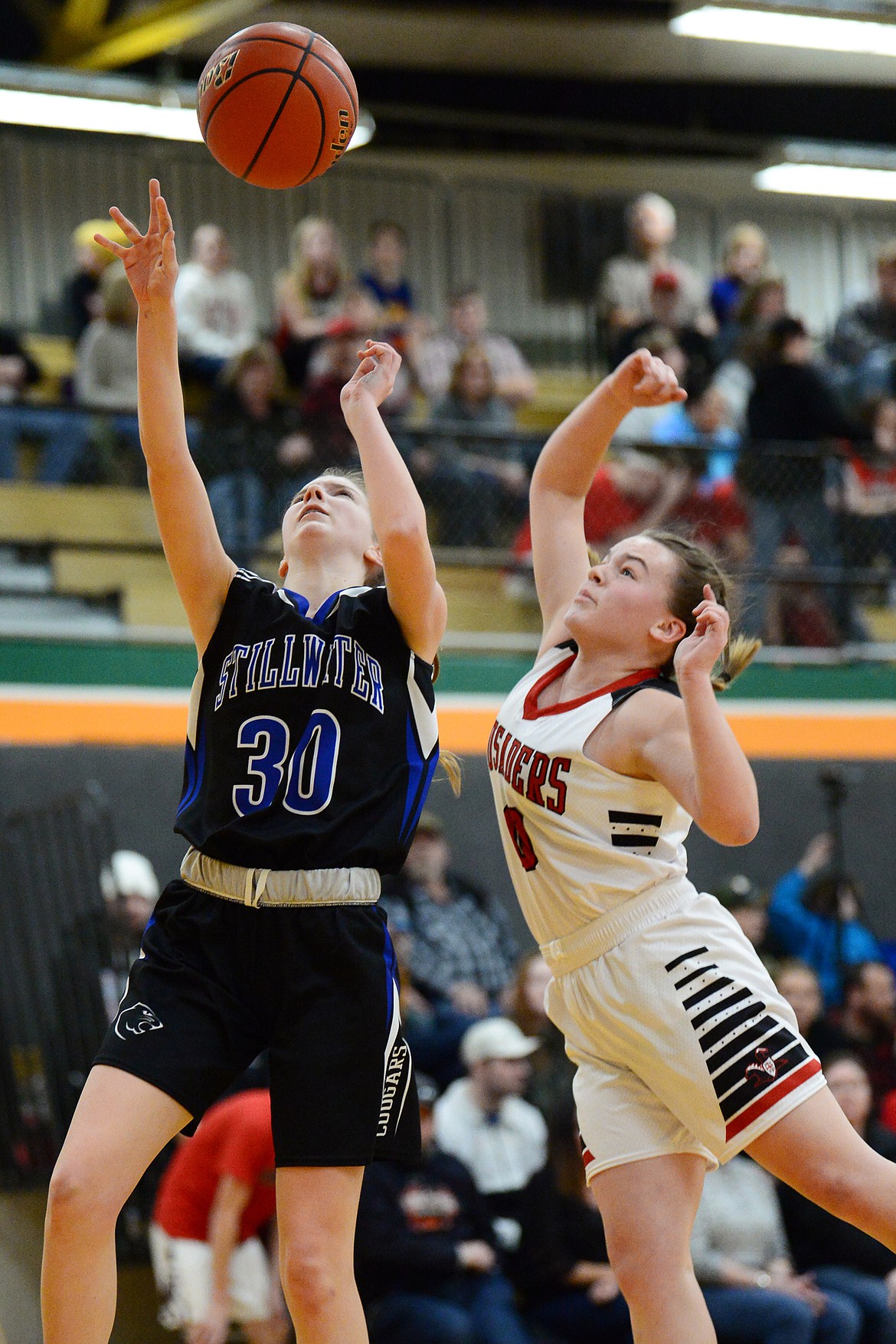 Flathead Valley Home School's Codi Kenney (10) blocks a layup by Stillwater Christian's Sophia Sulzbacher (30) at Kalispell Middle School on Saturday. (Casey Kreider/Daily Inter Lake)