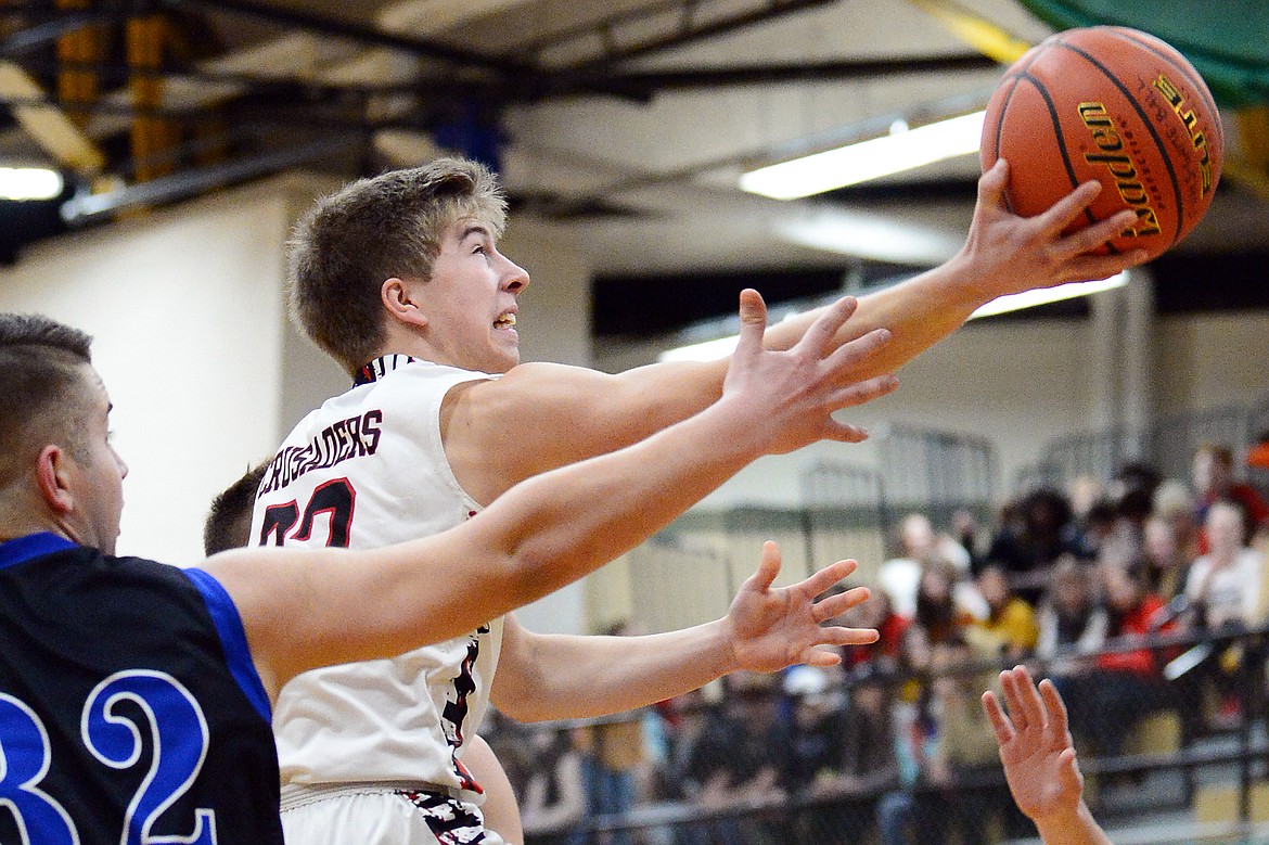 Flathead Valley Home School's Jordan Wininger (23) drives to the hoop against Stillwater Christian at Kalispell Middle School on Saturday. (Casey Kreider/Daily Inter Lake)