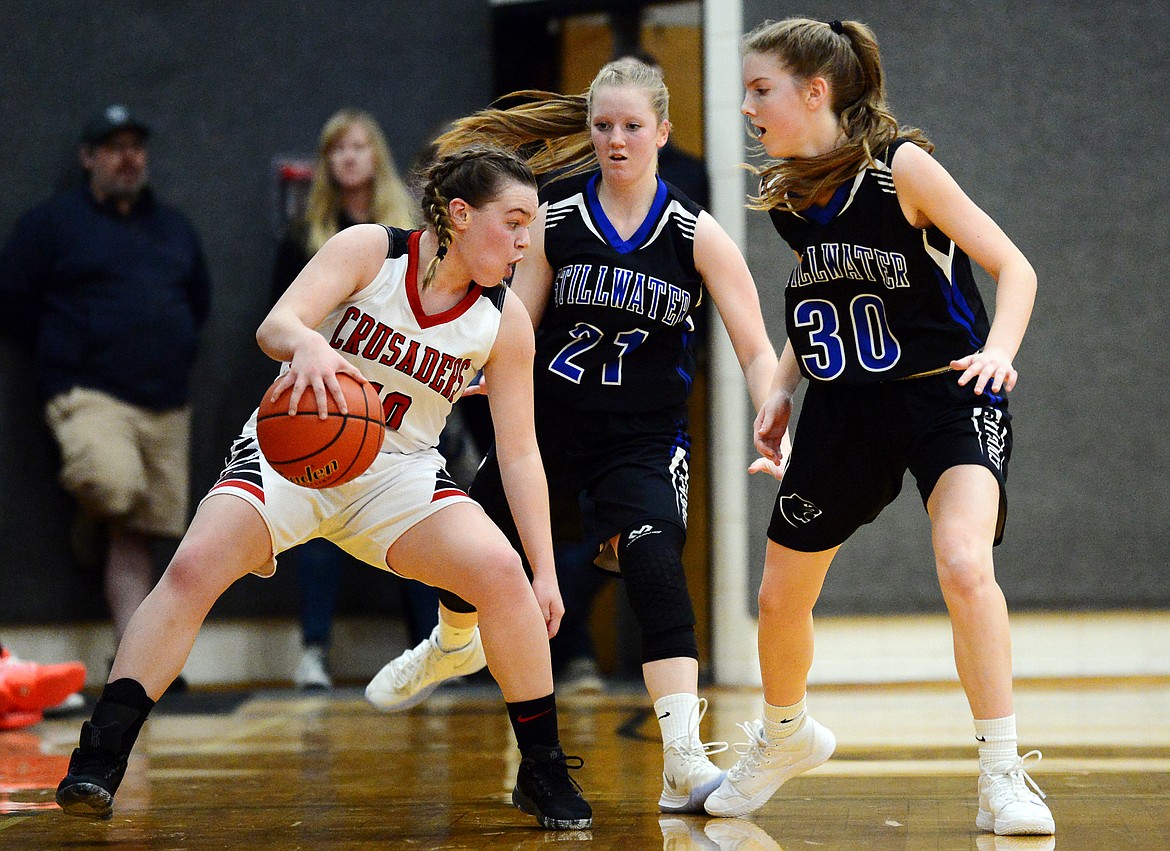 Flathead Valley Home School's Codi Kenney (10) looks to dribble out of a double-team against Stillwater Christian defenders Marae Tintzman (21) and Sophia Sulzbacher (30) at Kalispell Middle School on Saturday. (Casey Kreider/Daily Inter Lake)