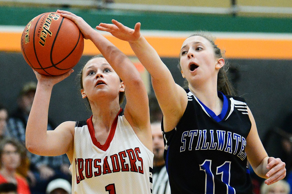 Flathead Valley Home School's Aurora Howery (1) drives to the hoop against Stillwater Christian's Grace Anderson (11) at Kalispell Middle School on Saturday. (Casey Kreider/Daily Inter Lake)