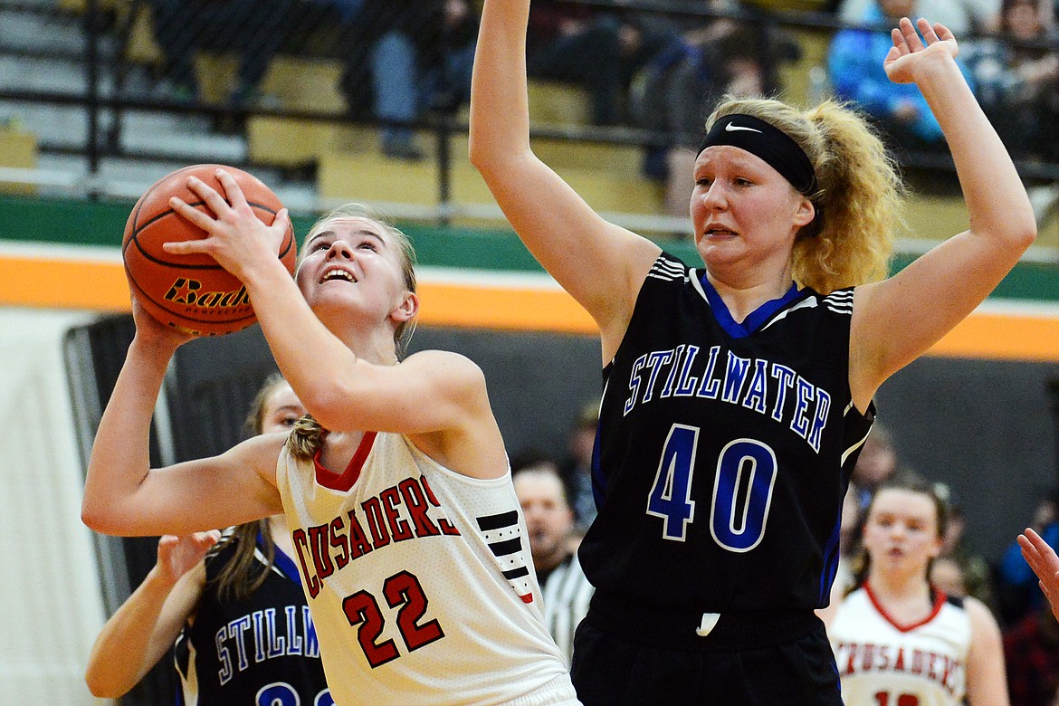 Flathead Valley Home School's Corey Connerly (22) looks to shoot against Stillwater Christian's Selah Neumann (40) at Kalispell Middle School on Saturday. (Casey Kreider/Daily Inter Lake)