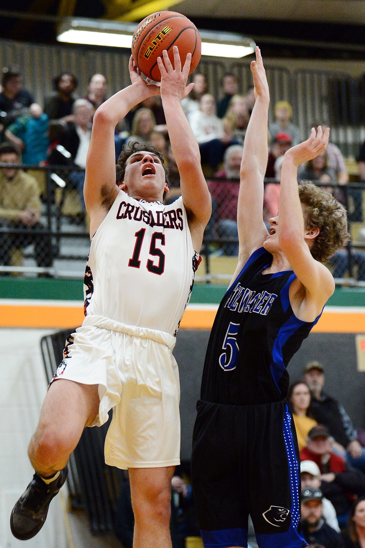 Flathead Valley Home School's Lee Artyomenko (15) drives to the basket against Stillwater Christian's Grady Drish (5) at Kalispell Middle School on Saturday. (Casey Kreider/Daily Inter Lake)