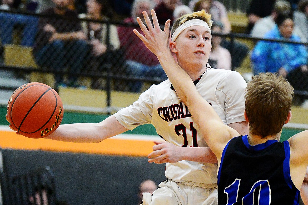 Flathead Valley Home School's Job Myers (21) looks to pass on his way to the hoop against Stillwater Christian at Kalispell Middle School on Saturday. (Casey Kreider/Daily Inter Lake)