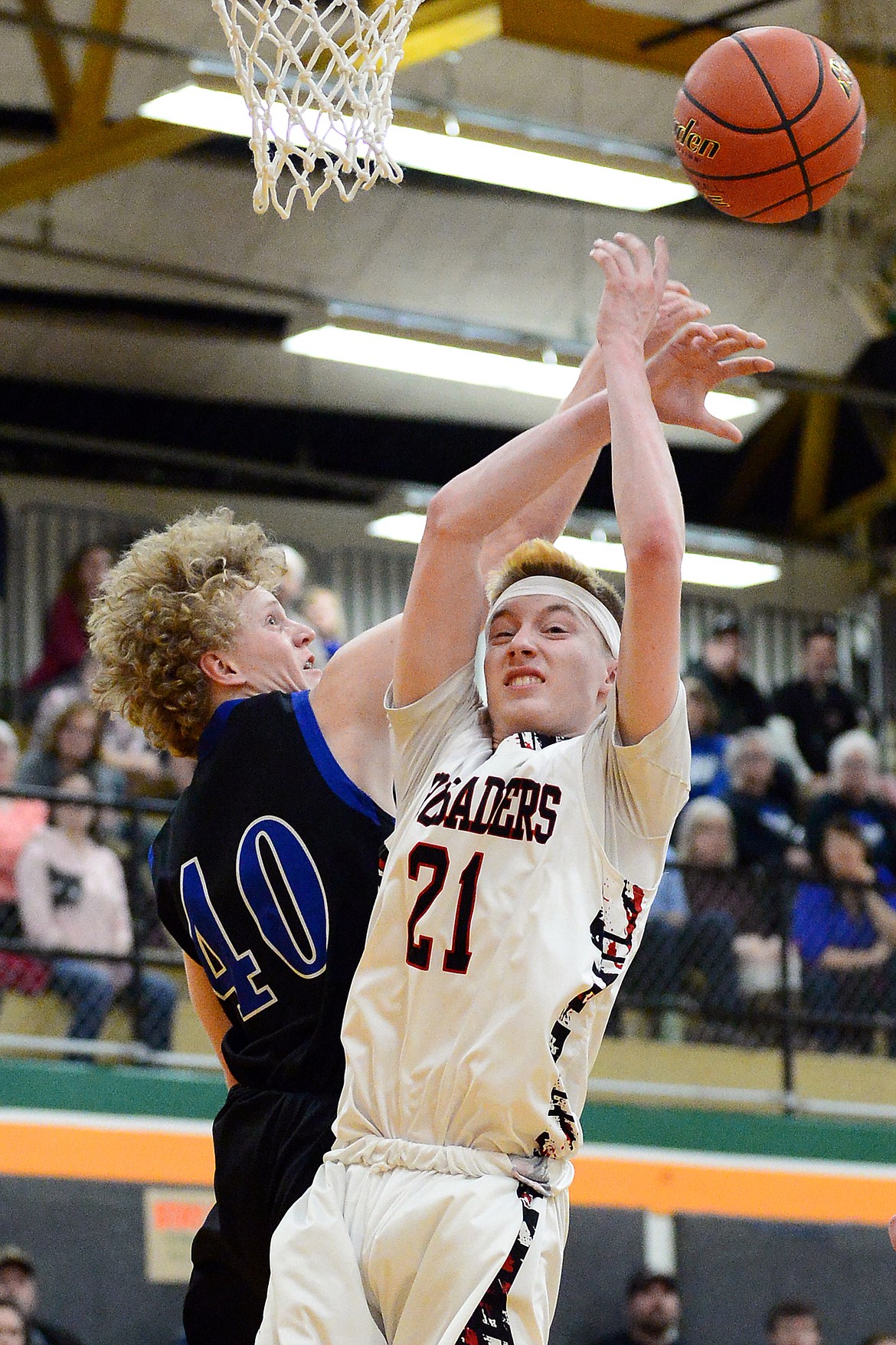 Stillwater Christian's Connor Drish (40) and Flathead Valley Home School's Job Myers (21) battle for a rebound at Kalispell Middle School on Saturday. (Casey Kreider/Daily Inter Lake)