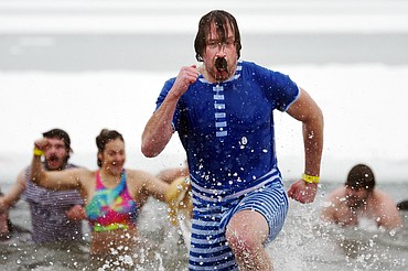 Kevin Steiner with Whitefish Credit Union hustles out of Whitefish Lake at the Whitefish Winter Carnival Penguin Plunge at City Beach on Saturday. (Casey Kreider/Daily Inter Lake)