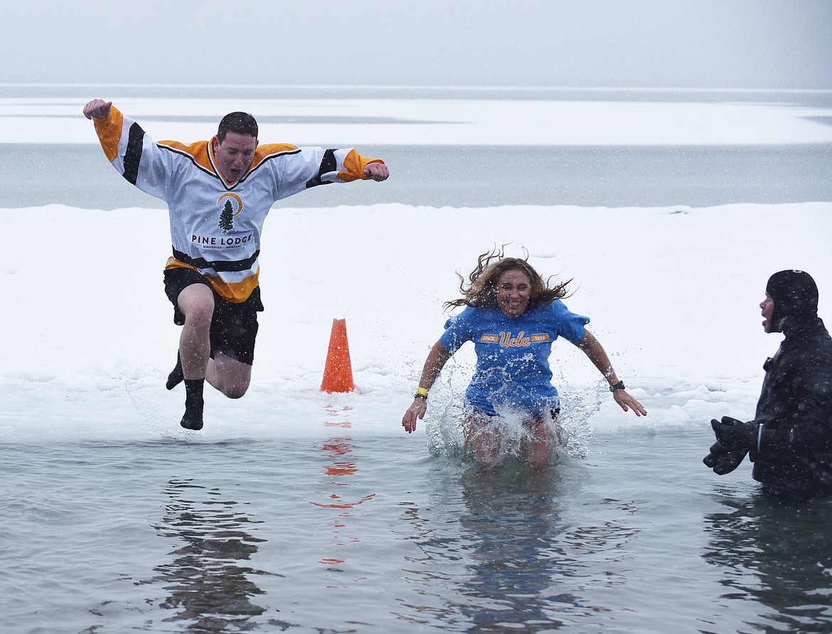 A group jumps into Whitefish Lake Saturday morning during the annual Penguin Plunge at City Beach. The event raises money for Special Olympics Montana. (Heidi Desch/Whitefish Pilot)