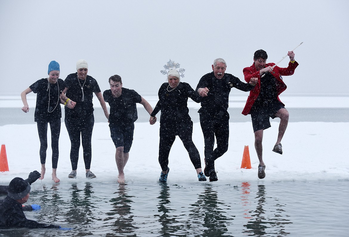 Members of the Whitefish Winter Carnival Royalty jump into Whitefish Lake Saturday morning during the annual Penguin Plunge at City Beach. The event raises money for Special Olympics Montana. (Heidi Desch/Whitefish Pilot)