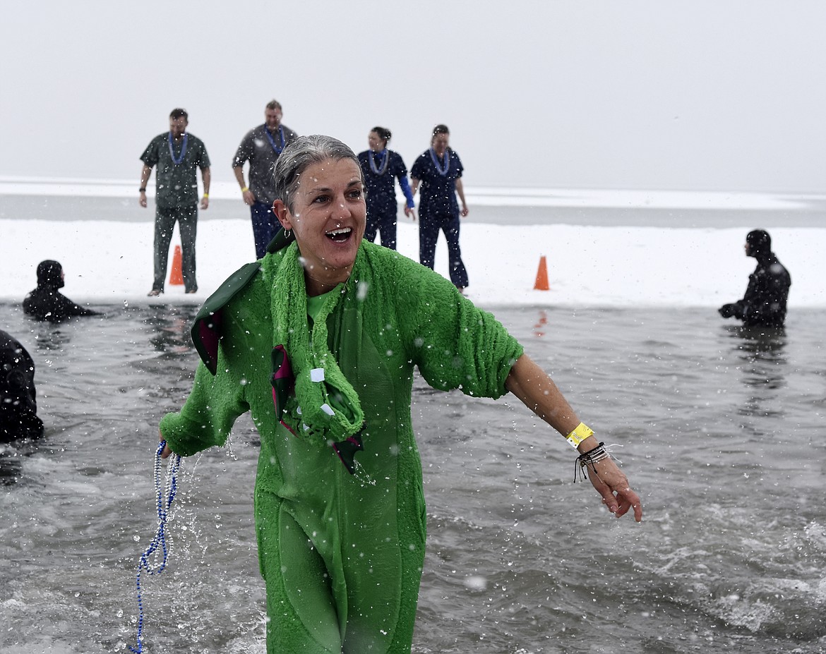 A participant from the North Valley Hospital team emerges from Whitefish Lake Saturday morning during the annual Penguin Plunge at City Beach. The event raises money for Special Olympics Montana. (Heidi Desch/Whitefish Pilot)