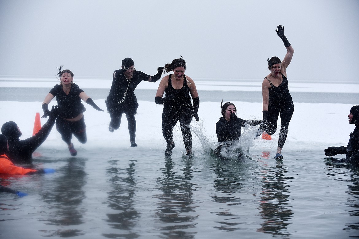 A group jumps into Whitefish Lake Saturday morning during the annual Penguin Plunge at City Beach. The event raises money for Special Olympics Montana. (Heidi Desch/Whitefish Pilot)