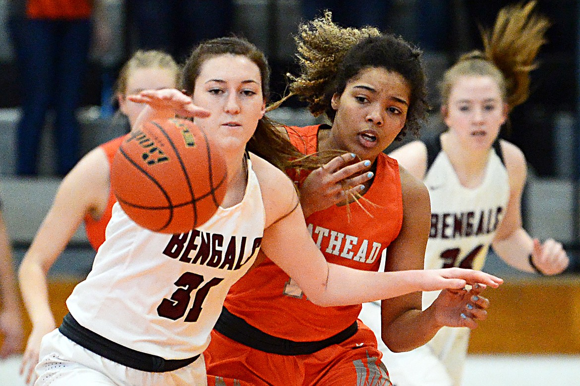 Flathead's Akilah Kubi (12) looks for a steal against Helena High's Abby Marcille at Flathead High School on Saturday. (Casey Kreider/Daily Inter Lake)