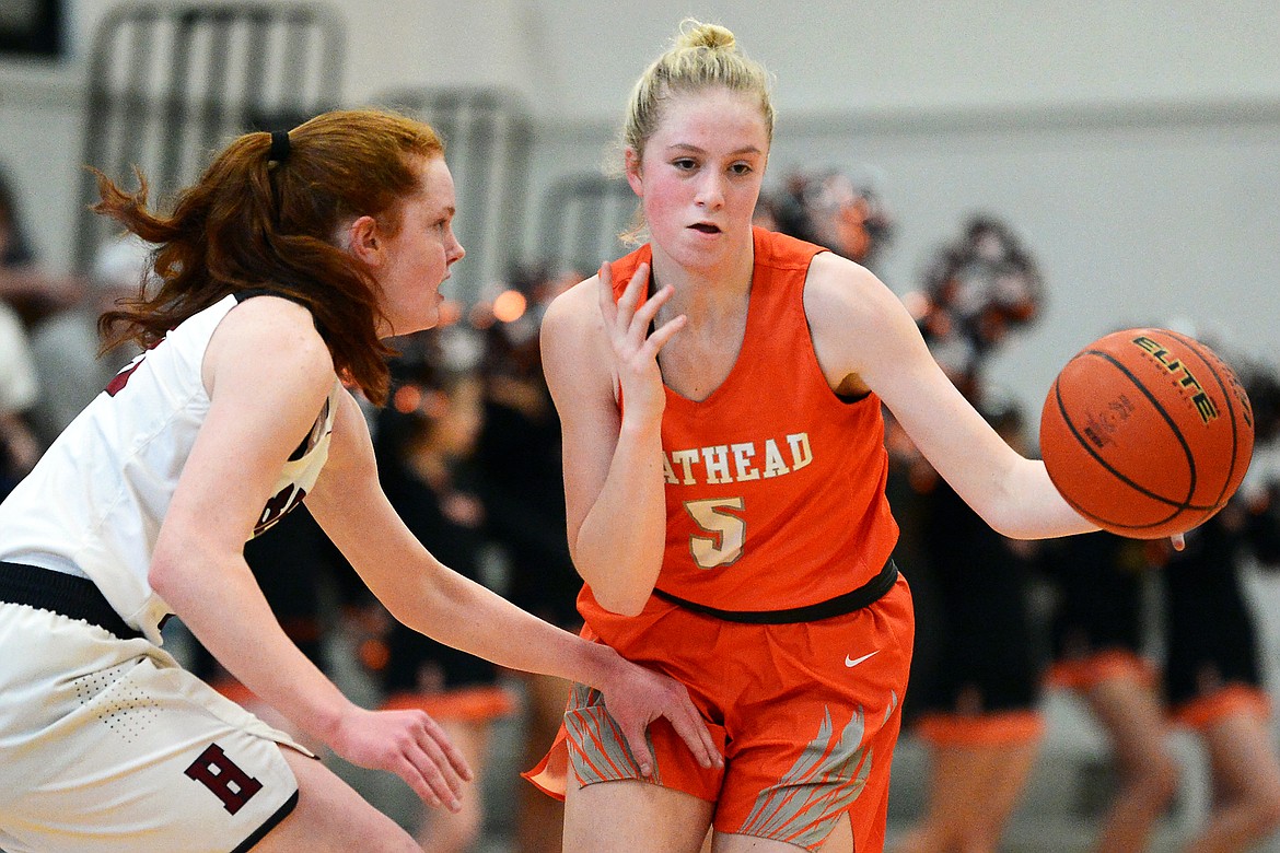 Flathead's Maddy Moy (5) brings the ball upcourt under pressure from Helena High's Kylie Lantz (23) at Flathead High School on Saturday. (Casey Kreider/Daily Inter Lake)