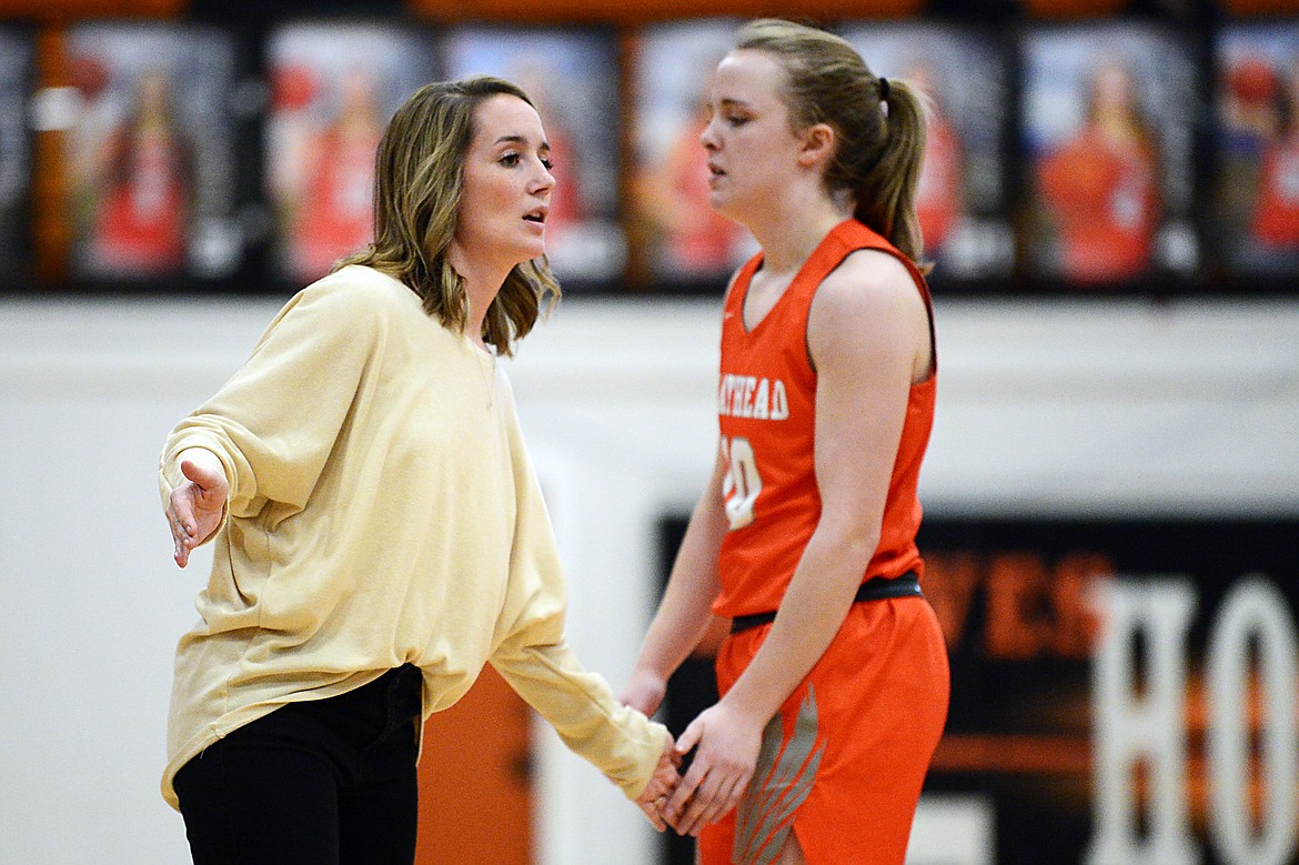 Flathead head coach Tricia Dean slaps hands with Kennedy Kanter (10) as she comes off the court against Helena High at Flathead High School on Saturday. (Casey Kreider/Daily Inter Lake)