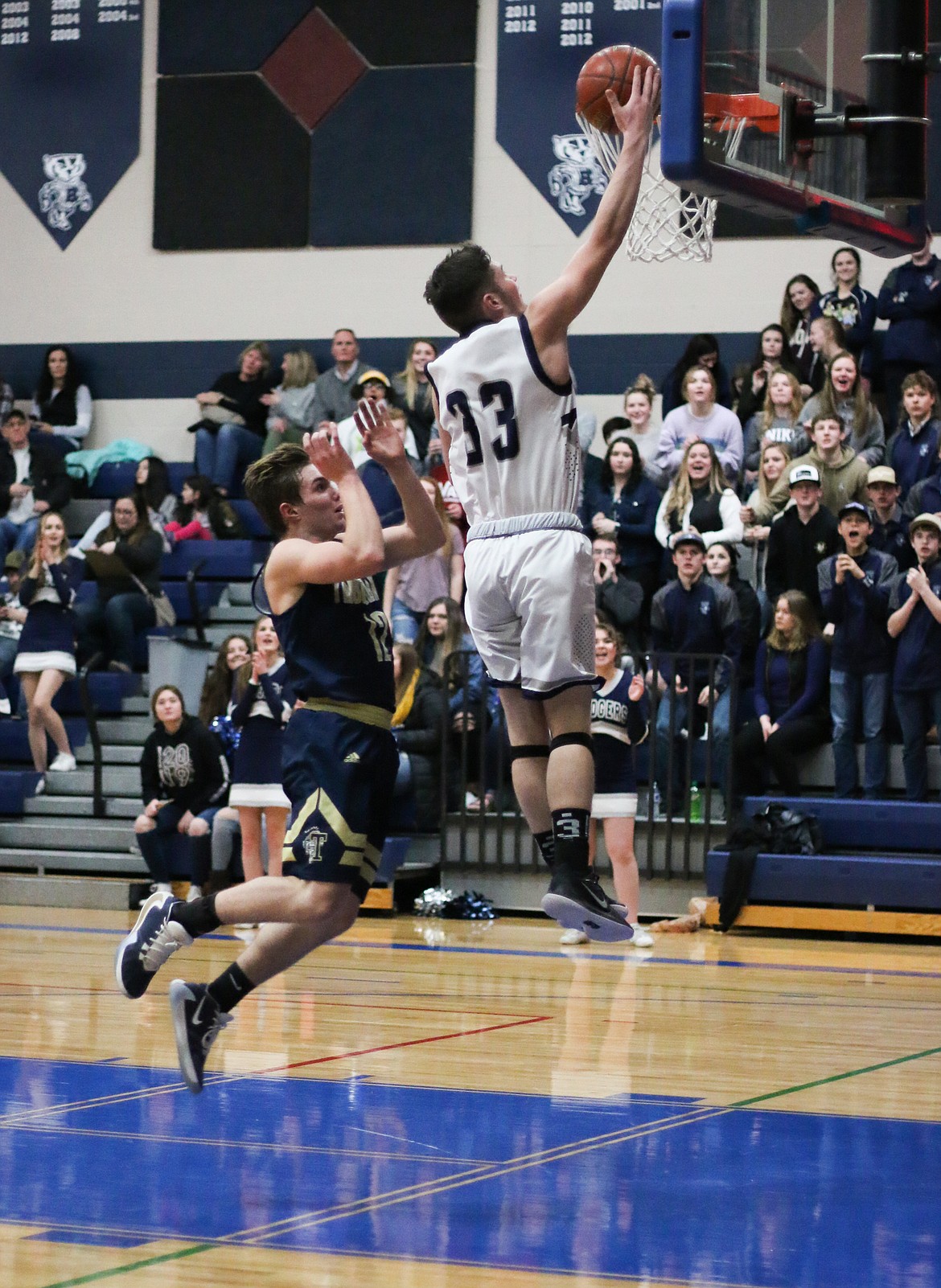 Photo by MANDI BATEMAN 
Braeden Blackmore dunks the ball.