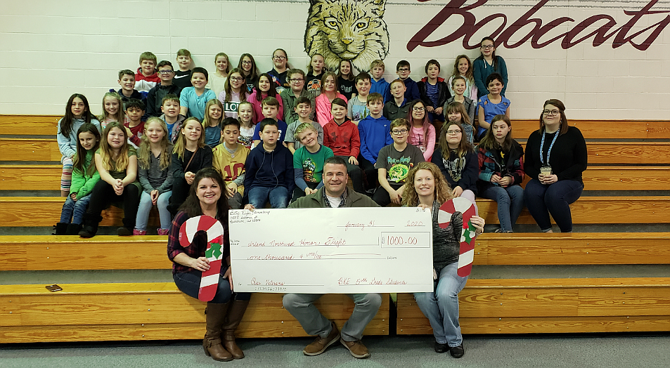 Shana Hostetler&#146;s fifth-grade class at Betty Kiefer Elementary School present a $1,000 check to Inland Northwest Honor Flight director Tony Lamanna during a ceremony Friday. The students raised $1,000 for the nonprofit selling candy canes for their Passion Project. Honor Flight is a program that transports war veterans to Washington, D.C., to see the memorials that honor their service and sacrifice. (Courtesy photo)