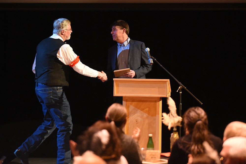 Whitefish Mayor John Muhlfeld accepts the award for Citizen of the Year from Kevin Gartland at the Whitefish Chamber's annual awards banquet last Thursday. (Daniel McKay/Whitefish Pilot)