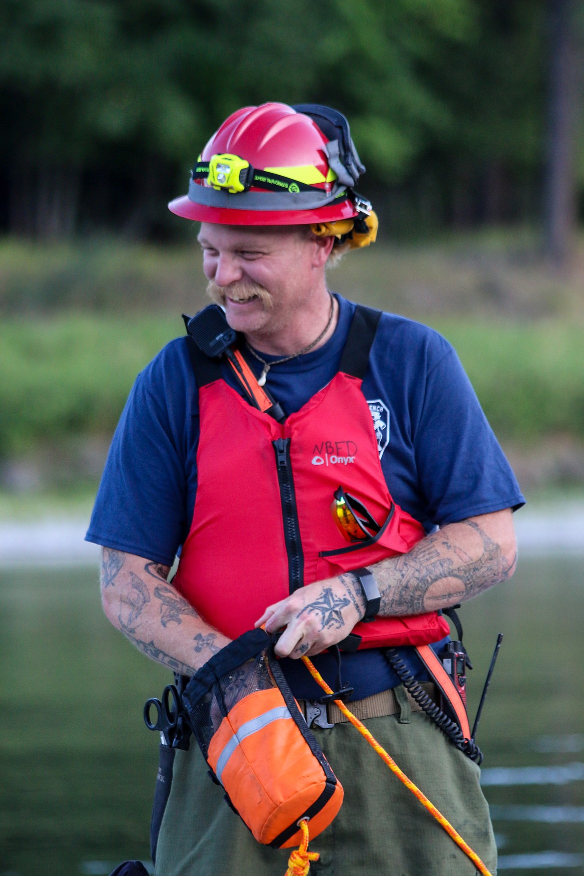 Photo by MANDI BATEMAN 
North Bench Firefighter Tom Chaney, known for always having a smile on his face, takes part in river rescue training.