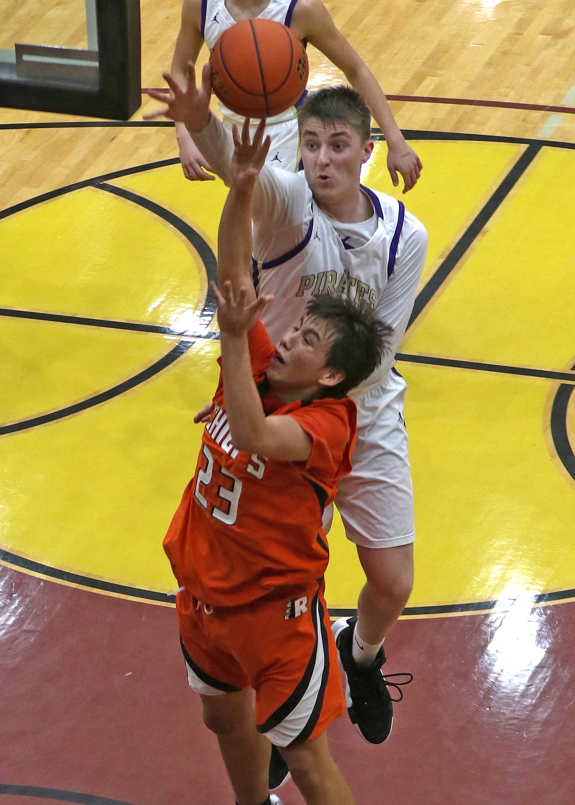 Chiefs guard Leonard Burke is blocked by Polson big man Trevor Lake during the rivalry game last Friday. (Bob Gunderson photo)