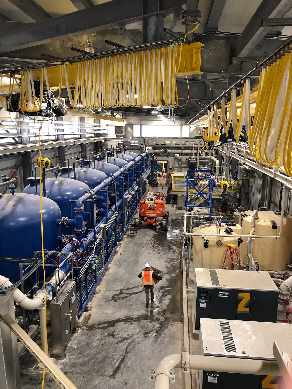 Inside the filter building you can see the massive filtration tanks on the left, and then on the right, you can see tanks that hold some of the treatment chemicals which get added to the water before it gets filtered. At the far end of the building, there is an access door to the underside of the clarifier tank.