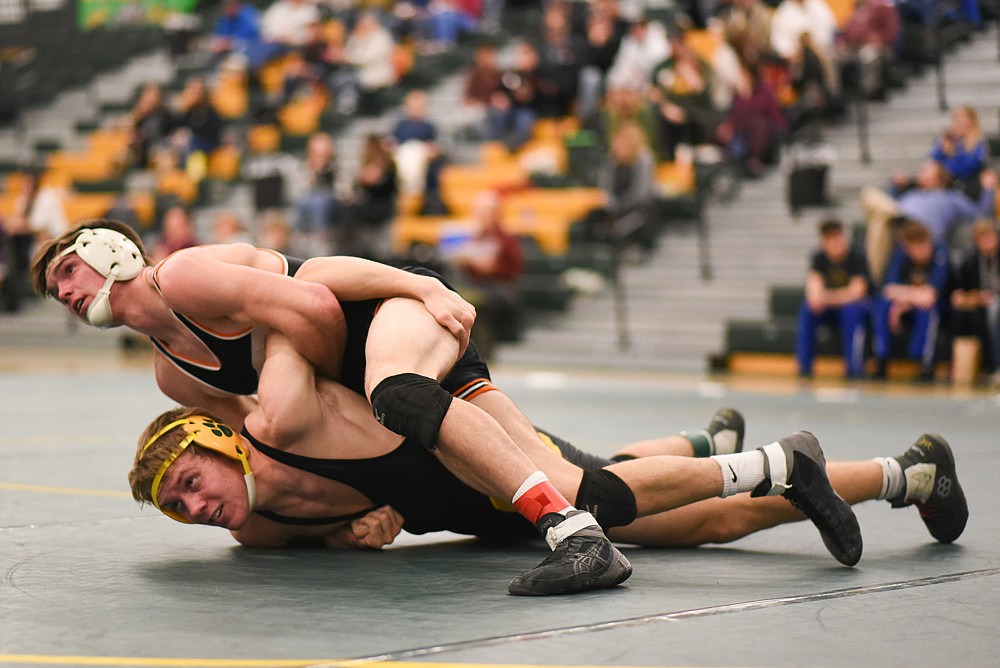 Camren Ross fights off a Eureka wrestler during the Bulldogs&#146; home invitational last Friday. (Daniel McKay/Whitefish Pilot)