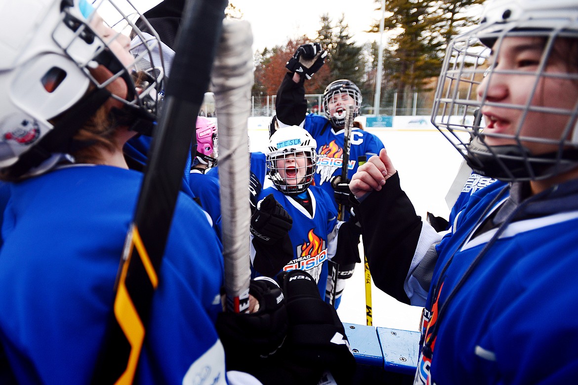 Tesla Liebe, center, fires up her teammates during an intermission against the Lethbridge Cyclones at the 14U Girls Winter Classic 2020 at the Woodland Ice Center in Kalispell on Friday. (Casey Kreider/Daily Inter Lake)